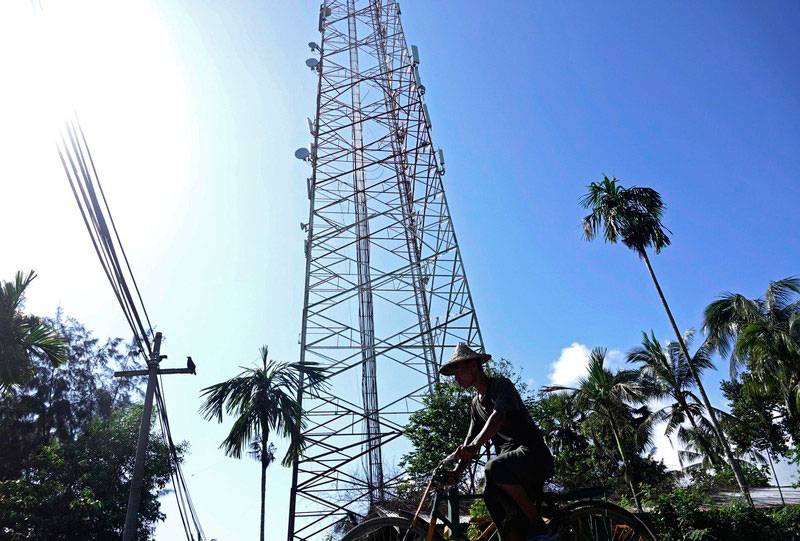 A Rakhine man rides a rickshaw past a telecommunications tower in Sittwe, Rakhine state, Myanmar, 22 June 2019. Photo - EPA
