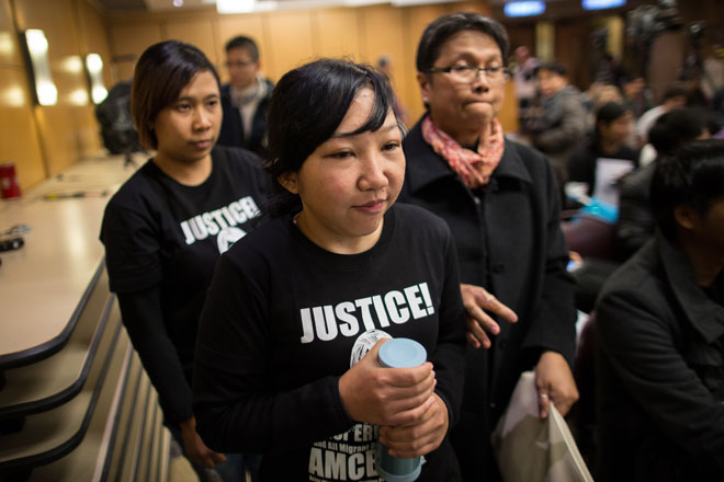 Former Indonesian maid Ms Erwiana Sulistyaningsih (C) arrives at a press conference in Hong Kong, China, February 10, 2015. Photo: Jerome Favre/EPA