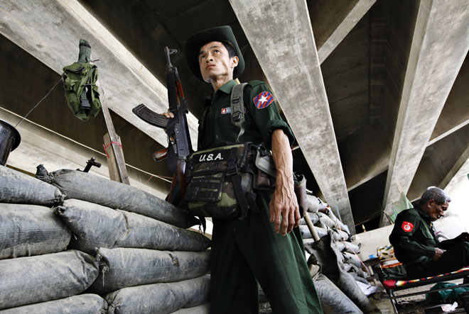 A Myanmar Border Guard Forces guard near a bunker at the 'Friendship Bridge' Thailand-Myanmar border bridge gate in Myawaddy, Kayin State, Myanmar, October 3, 2014. Photo: Lynn Bo Bo/EPA