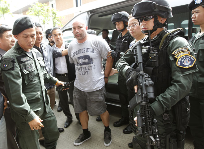 Cracking down on the illegal drug trade in the Golden Triangle is a tough call. Alleged American drug trafficker Joseph Manuel Hunter (C) is escorted by Thai commandos as he arrives to board a chartered jet for extradition to the USA at Don Mueang airport in Bangkok, Thailand, September 27, 2013. Photo: Narong Sangnak/EPA
