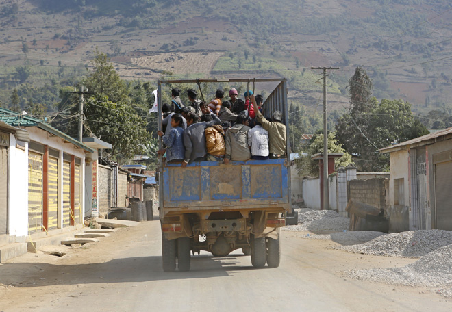 A rescue truck loaded with victims of the fighting leaves the Kokang capital Laukkai, northern Shan State, Myanmar, February 17, 2015. Photo: Lynn Bo Bo/EPA