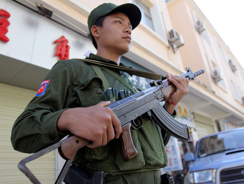 A Kokang ethnic soldier standing guard outside a hotel as journalists and diplomats attend press conference at the hotel in Myanmar-China border town Laukkai, Myanmar on September 9, 2009. Photo: Khin Maung Win/EPA