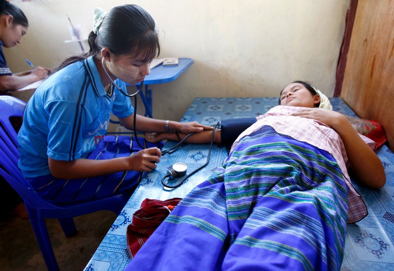 A Karen health worker gives a medical check up to a Karen pregnant woman at Paw Bu La Hta clinic in Kow Poe Kee village, Kayan State, Myanmar on April 3, 2008. Photo: Rungroj Yongrit/EPA