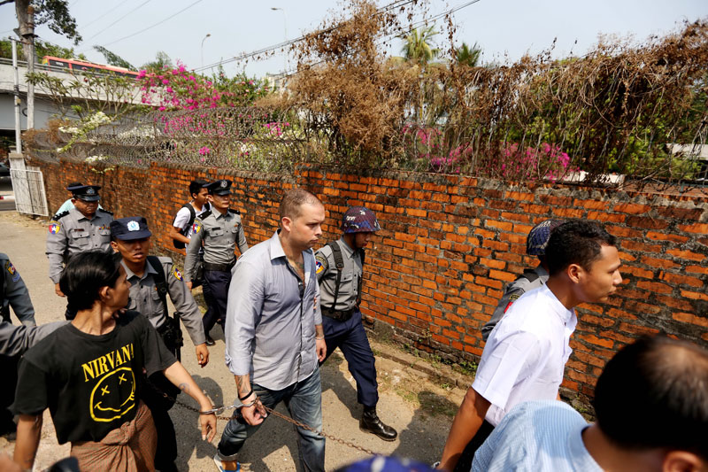 Philip Blackwood (C), with U Tun Thurein and U Htut Ko Ko Lwin being taken to court on March 17, 2015. They were sentenced to two and a half years in jail over the posting of an image of Buddha wearing headphones on Facebook. Photo: Thet Ko/Mizzima