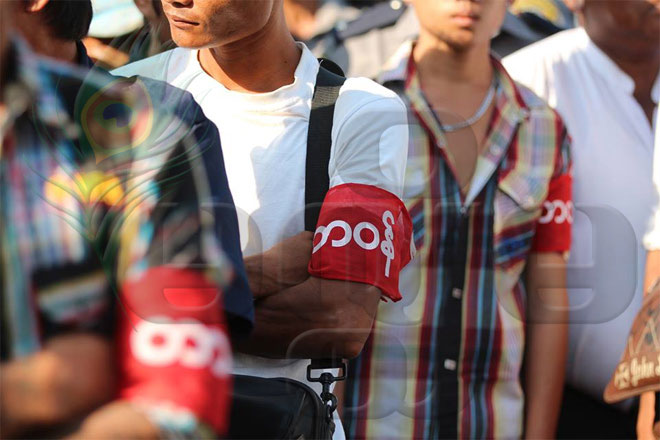 Civilians wearing red armbands with the word “Duty” on them launched a violent crackdown on activists and students protesting outside the Yangon City Hall on March 5, 2015. Photo: Hein Htet/Mizzima