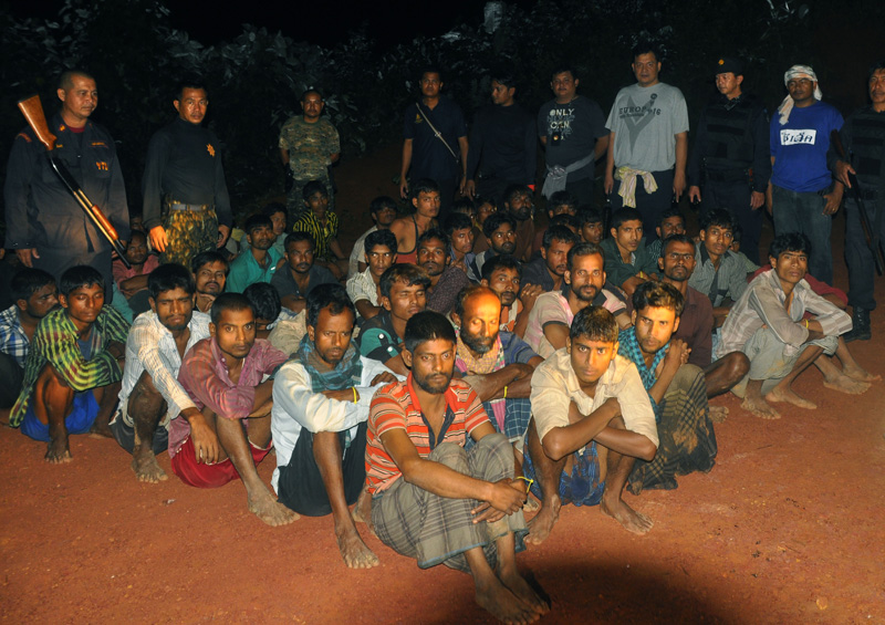 Dozens of Myanmar migrants including several Rohingya have just been arrested in southern Thailand. Here ethnic Rohingya refugees sit waiting after Thai police officers arrested them in Phang Nga province, southern Thailand, October 11, 2014. Photo: EPA