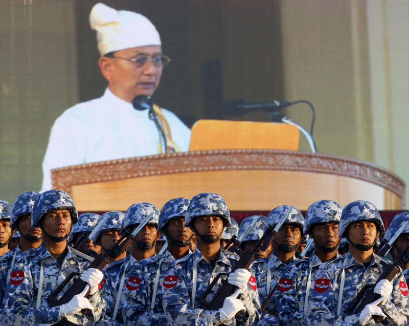 President U Thein Sein delivers a speech as seen on a background display as Myanmar Airforce soldiers participate in a ceremony to mark the 67th anniversary of Myanmar's Independence day, in Nay Pyi Taw, Myanmar, January 4, 2015. Photo: Lynn Bo Bo/EPA
