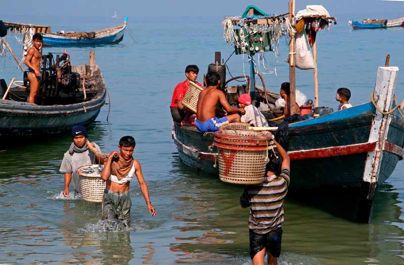 Southeast Asia's fishing industry is in trouble, with problems of overfishing and allegations of slavery. Fishermen unload their catch from small fishing boats at Jatetaw fishing village, Ngapali beach, Myanmar. Photo: Gernot Hensel/EPA