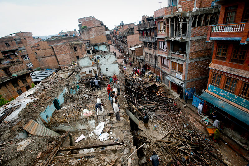 People look through the rubble trying to salvage as much as possible from their dilapidated houses destroyed in the 25 April earthquake in Bhaktapur, Kathmandu, Nepal, April 29, 2015. Photo: Diego Azubel/EPA