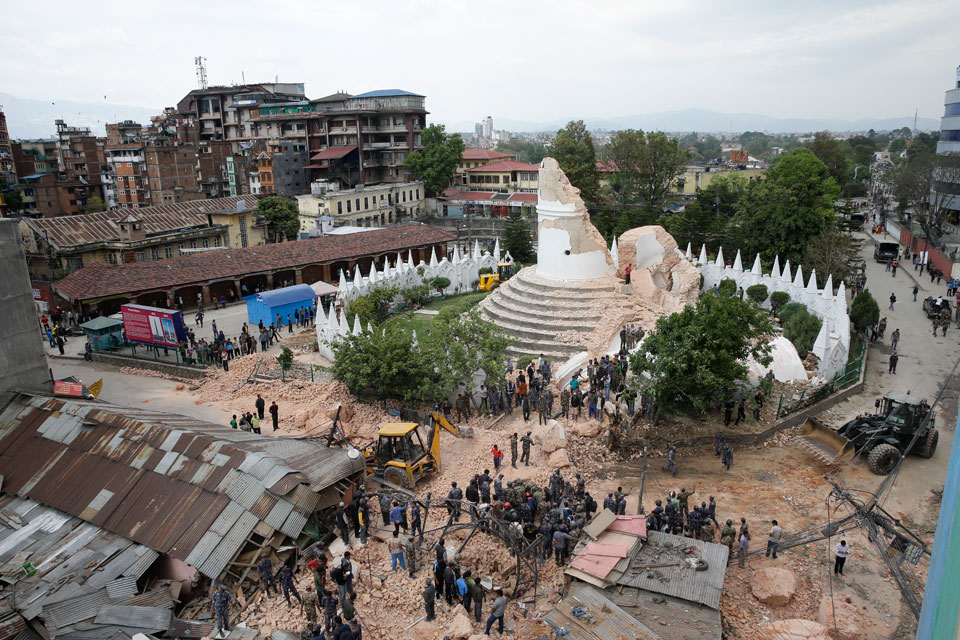 People inspect the damage to the collapsed landmark Dharahara, also called Bhimsen Tower, after an earthquake caused serious damage in Kathmandu, Nepal, April 25, 2015. Photo: Narendra Shrestha/EPA