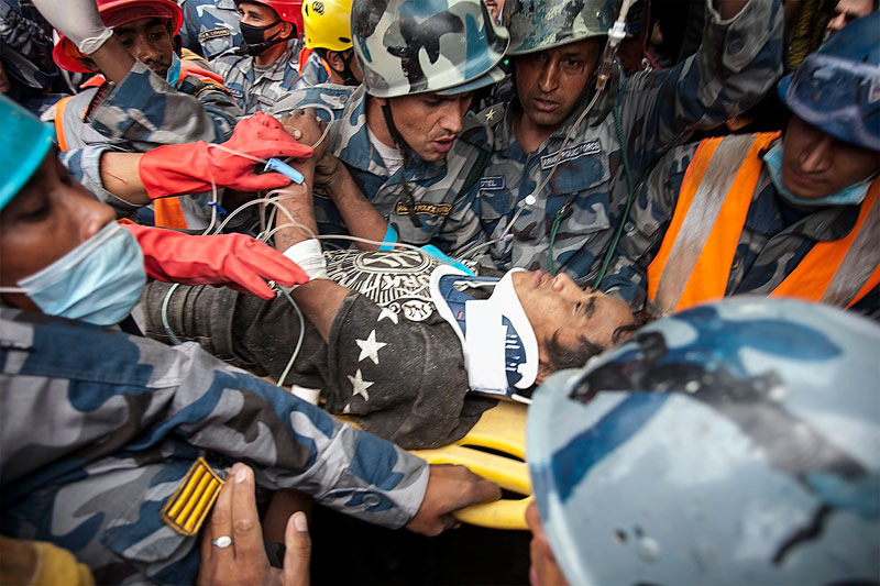 Pemba Tamang, 15, is taken on a stretcher after being rescued by Nepal Armed Police Force from the collapsed building of the Hilton Hotel, five days after a major earthquake, in Kathmandu, Nepal, April 30, 2015. Occasional rays of hope in the form of unexpected rescues emerged on 30 April, in the wake of Nepal's devastating weekend earthquake even as the official death toll rose above 5,000. Photo: Hemanta Shrestha/EPA