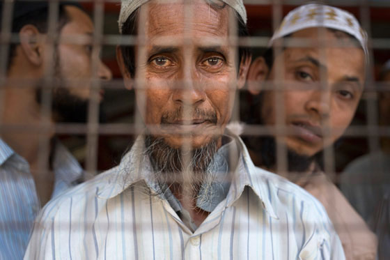 A Rohingya man looks out from behind the gate of a mosque near Sittwe, the capital of Rakhine State. Photo: Paula Bronstein/Getty Images Reportage for the United States Holocaust Memorial Museum