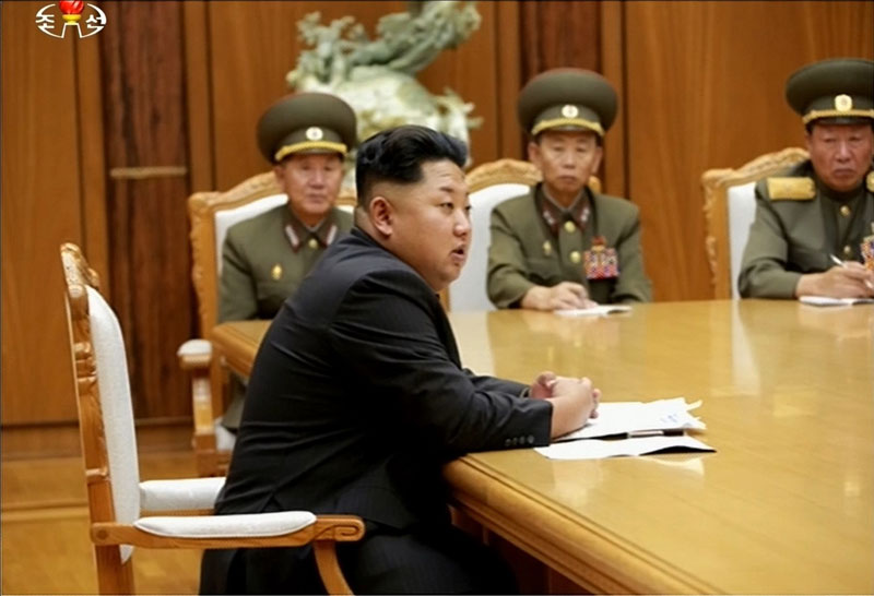 North Korean leader Kim Jong-un (front) presiding over an emergency meeting of the central military commission of the Workers' Party after both Koreas exchanged fire across the western border 20 August 2015. Photo: EPA