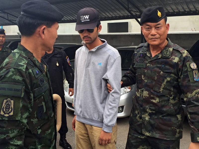 Royal Thai Army soldiers lead a suspect allegedly connected with the Erawan Shrine bombing after they arrested him in Sa Kaeo district, near the Thai-Cambodian border, 1 September 2015. Photo: EPA
