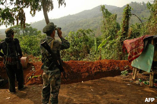 Kachin Independence Army (KIA) soldier looking through binoculars at positions of the Burmese army from an outpost some 12 kilometers south of Laiza, a KIA-controlled stronghold in northern Kachin State on the border with China. Photo: AFP
