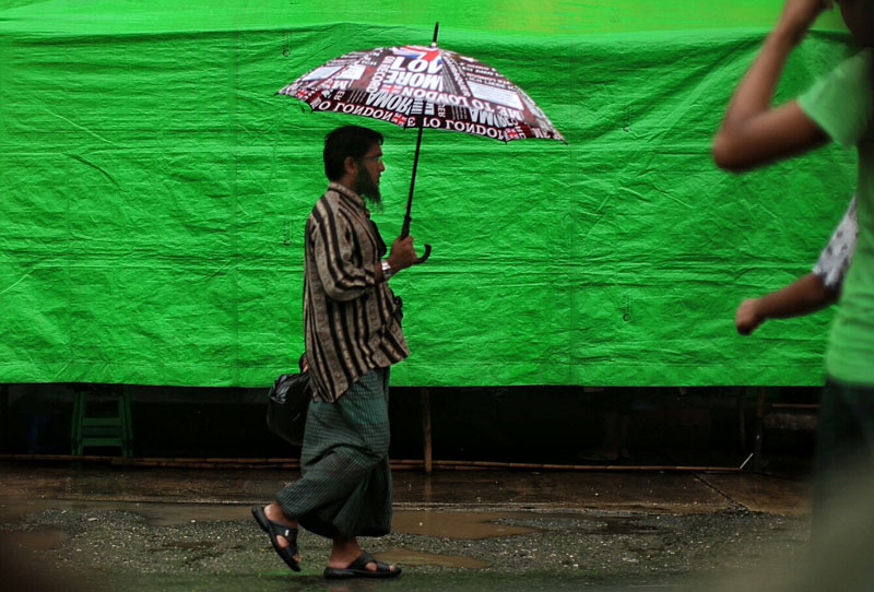 Muslim man walks on a busy street in downtown Yangon. Photo: Khun Lat, Myanmar Now