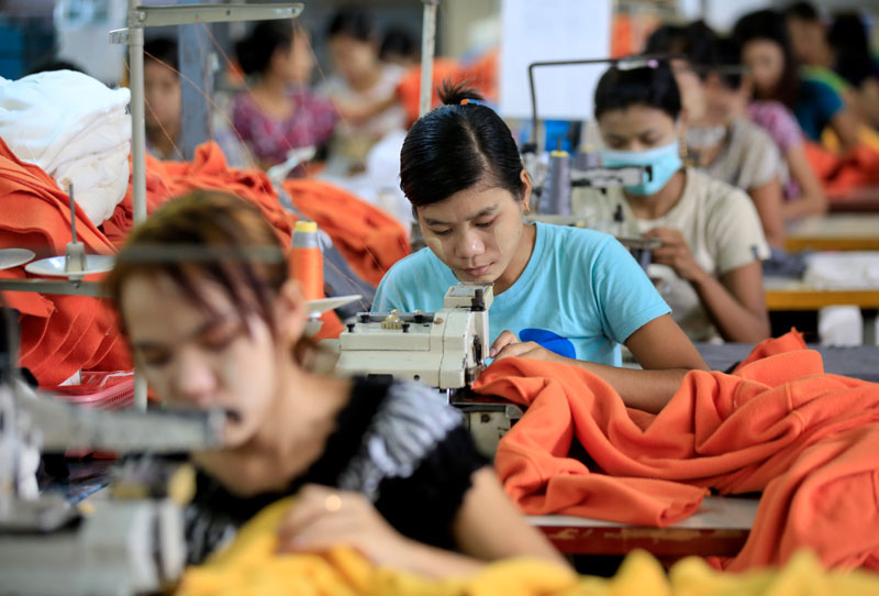 Myanmar girls work in a garment factory at Hlaing Thar Yar Industrial Zone in Yangon, Myanmar, 10 July 2015. Photo: Lynn Bo Bo/EPA