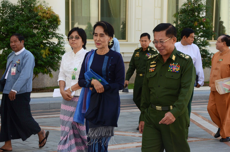 Myanmar military commander-in-chief Senior General Min Aung Hlaing and Myanmar opposition leader Aung San Suu Kyi arrive to attend a high-level meeting at the President's resident office in Nay Pyi Taw on 31 October 2014. Photo: MNA