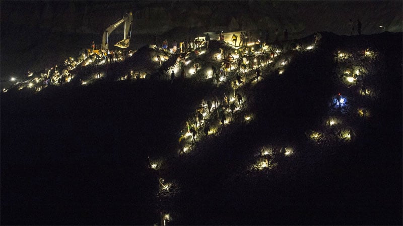 The sun may set, but the mine still teems with workers throughout the night. Photo: Minzayar