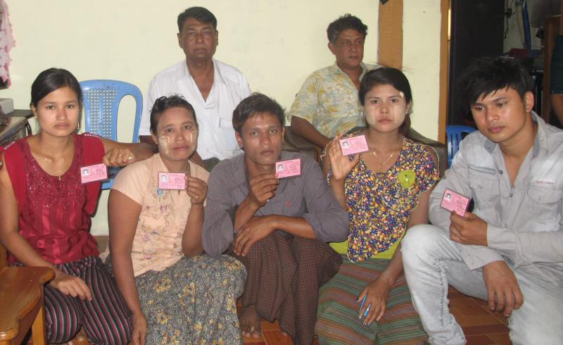 Several of the Kaman Muslims, holding their ID cards. Photo: Myanmar Now