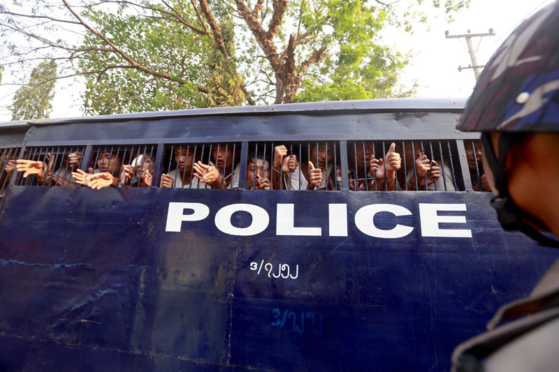 Student protesters look out from a police vehicle at Letpadan Township Court, Bago division, Myanmar, 11 March 2015. Photo: Nyein Chan Naing/EPA