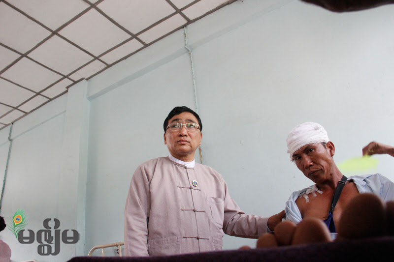 Minister of Ministry of Social Welfare, Relief and Resettlement Dr Win Myat Aye visits a patient in hospital.
