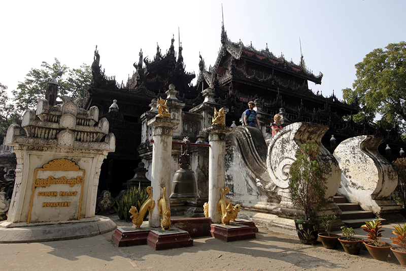 Tourists visit the Shwe Kyaung (Golden Temple) Buddhist temple in Mandalay, Myanmar, 08 December 2015. Shwe Kyaung also know as Shwe Nandaw Kyaung Monastery is constructed entirely of teak wood and wooden architecture of ancient Myanmar in the mid-nineteenth century by King Mindon. It was initially a part of the palace at Amarapura and it is the single remaining original structure of the Royal Palace. Photo: Hein Htet/EPA