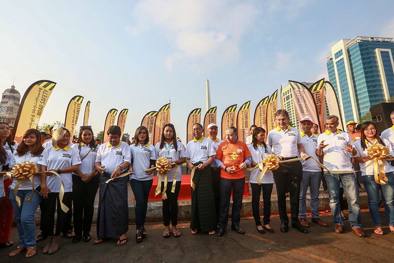 Yangon officials and volunteers prepare for the ribbon-cutting ceremony at Maha Bandoola Park to launch the "Start With Me" road safety campaign on 4 April 2017.