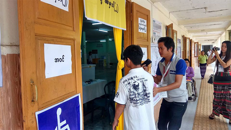 A differently-abled person enters the polling station No. 2 to cast his vote for by-elections on 1 April, 2017. Photo: Mizzima