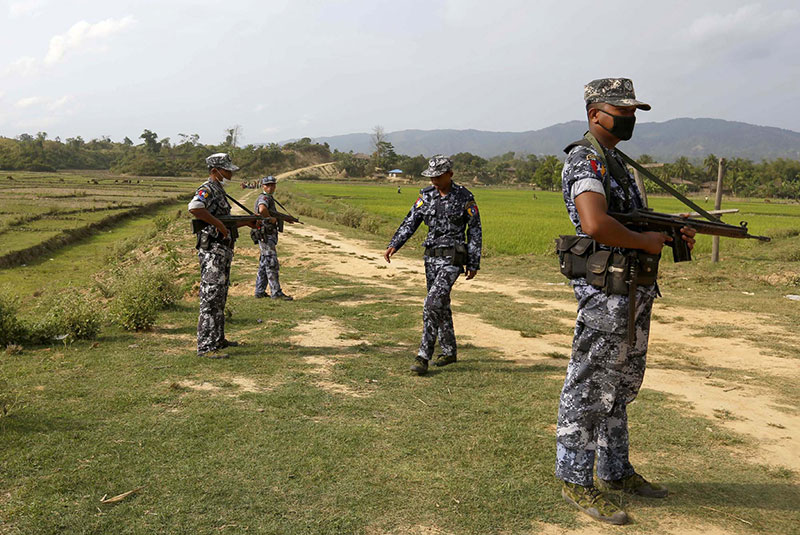 Members of the border guard police force stand guard at Tin May village, near Butheetaung town on the Bangladesh-Myanmar border, Rakhine State, Myanmar. Photo: Nyein Chan Naing/EPA