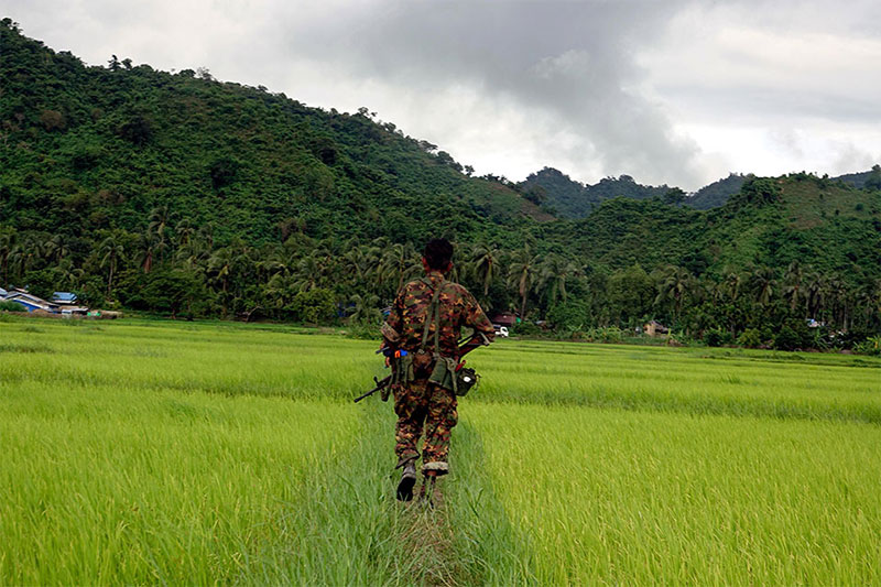 Myanmar soldier walks in Chain Khar Li Rakhine ethnic village, an area close to fighting at Rathedaung township of northern Rakhine State, western Myanmar, 25 August 2017. Photo: Nyunt Win/EPA