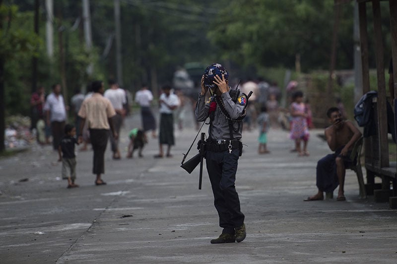 An armed Myanmar police officer stands guard in Aung Mingalar ward in Sittwe, the capital of Rakhine State. Photo: AFP