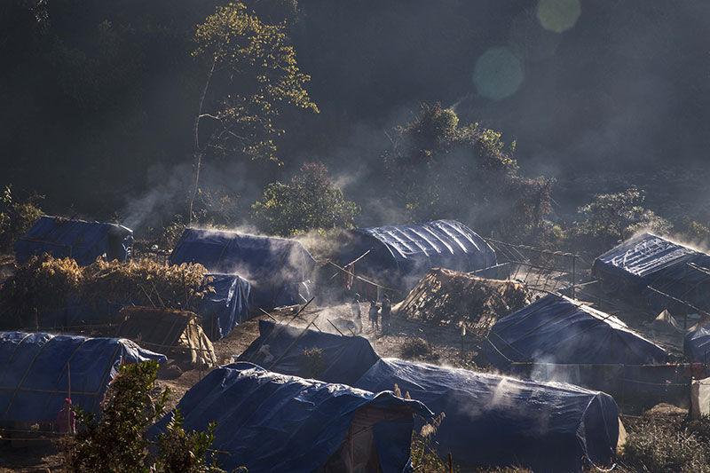Refugees in front of their temporary shelter near Lung Byeng village, Waimaw