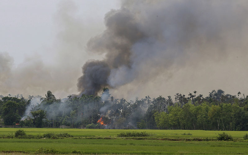 Smoke and flames rise from the Gawdu Thara village in Maungdaw