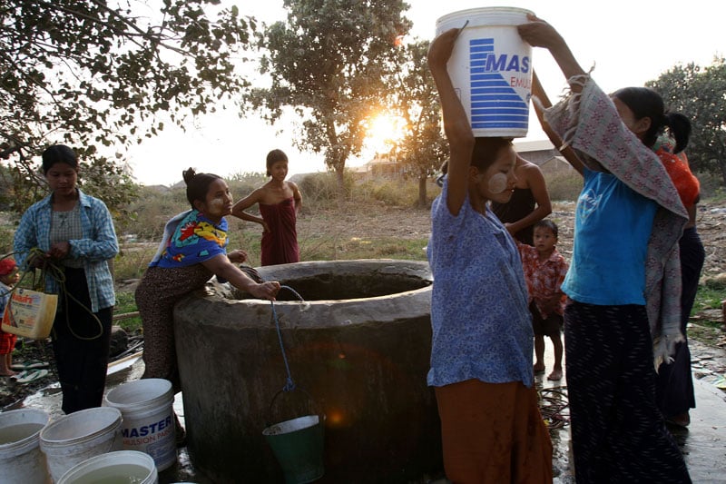 Residents carry away water for their daily usage from a well in a remote Pyinmana town close to the Myanmar's new administrative capital Nay Pyi Taw. Photo: AFP