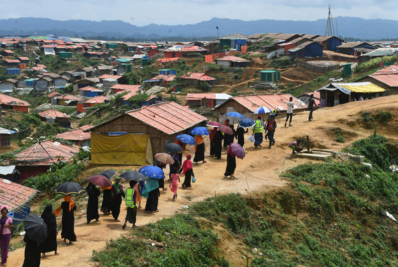 Rohingya refugee volunteers walk along Balukhali refugee camp in Ukhia district near Cox's Bazar on August 23, 2018. Photo: Dibyangshu Sarkar/AFP