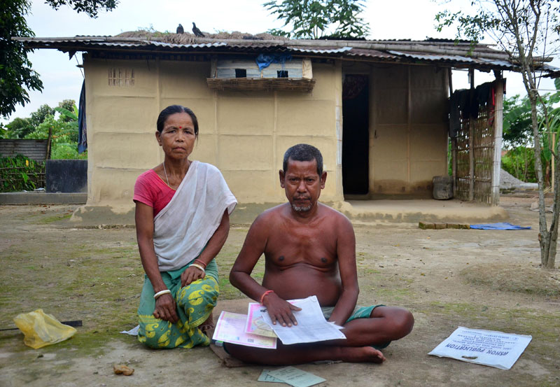 Victims of the crackdown - This photo taken on August 8, 2018 shows Nimai Hajong and his wife Sinibala Hajong sitting in front of their house in Bamunigaon village in Assam's Kamrup district. Photo: A. Sharma/AFP