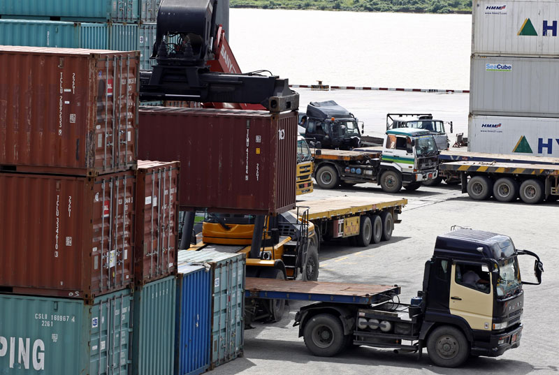 A truck loads containers at the Ahlone international terminal port in Yangon. Photo: Nyein Chan Naing/EPA