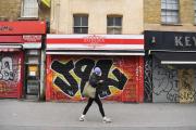 A man walks past closed shops in east London, Britain, 15 January 2021. Photo: EPA