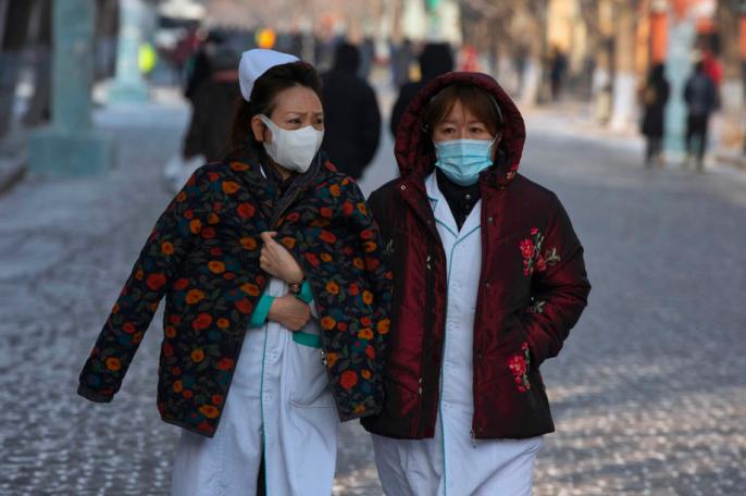 Medical staff walk on the street in Harbin, Heilongjiang province, China, 15 January 2021. Photo: EPA