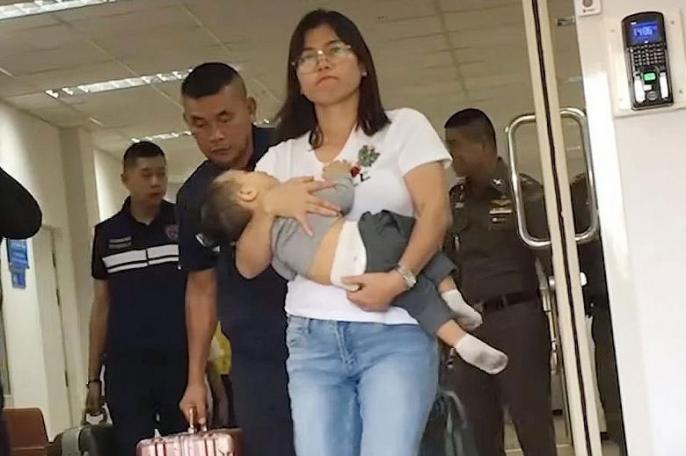 The wife of Myanmar's Arakan Army leader, Ms Hnin Zar Phyu, seen here with one of their children, had been detained in Thailand. Photo: RFA/YouTube