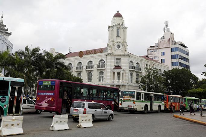 Buses stand in a traffic jam in front of the Ayeyarwady Bank (AYA Bank) in downtown Yangon. Photo: Nyein Chan Naing/EPA