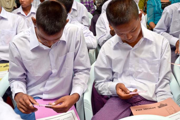 Myanmar boys, who were released from the Myanmar army, look at their new National Registration Cards at a releasing ceremony of 42 child soldiers as part of the implementation of an action plan between the Myanmar government and the United Nations (UN), signed in late June 2012, in Yangon, Myanmar, 03 September 2012. Photo: EPA