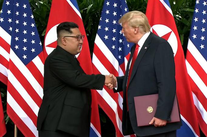 North Korea's leader Kim Jong Un (L) shakes hands with US President Donald Trump (R) after taking part in a signing ceremony at the end of their historic US-North Korea summit, at the Capella Hotel on Sentosa island in Singapore on June 12, 2018. Photo: AFP