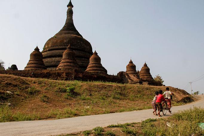Children play near ancient pagodas at Mrauk U of Rakhine State, western Myanmar, 15 Febuary 2016. Photo: Nyunt Win/EPA