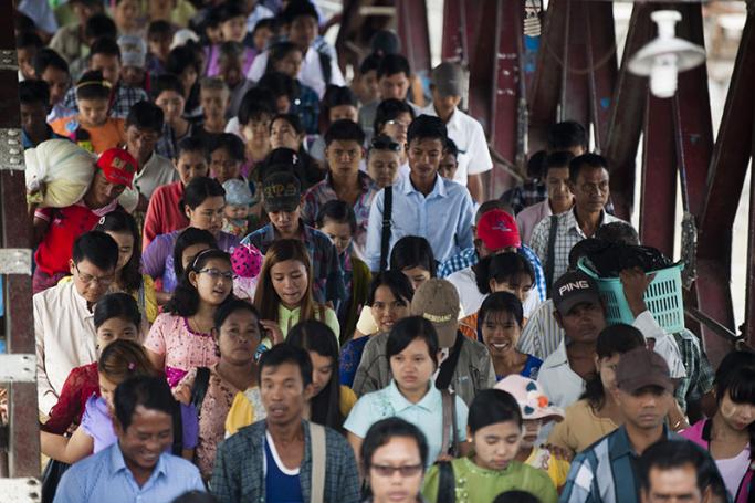 Passengers disembark from a ferry onto a jetty in Yangon. Photo: Ye Aung Thu/AFP