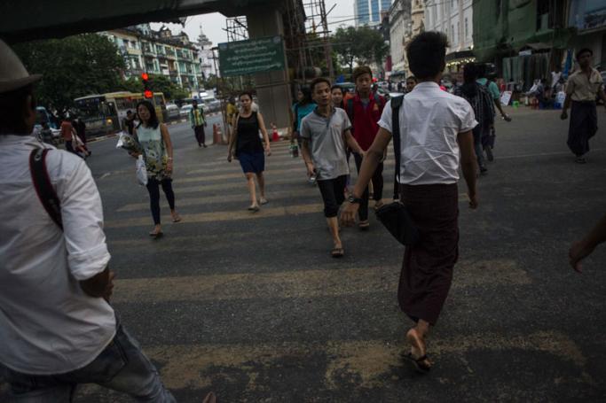 Pedestrians crossing a street in Yangon. Photo: Ye Aung Thu/AFP