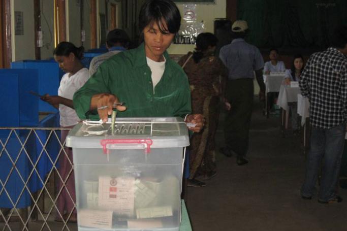 A young man casts his vote at a polling booth in Kyimyidine township, Yangon on 7 November, 2010. Photo: Mizzima
