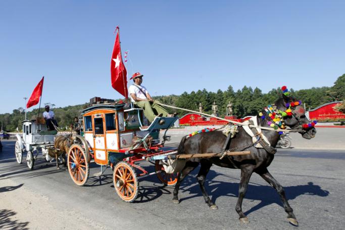 Members of National League for Democracy (NLD) party steer horse-drawn coaches during an election campaign rally in the town of Pyin Oo Lwin, Mandalay region, Myanmar, 24 October 2015. Photo: Hein Htet/EPA