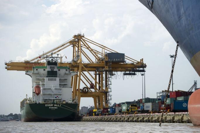 Ships and gantry cranes are seen at the container port facility of the Asia World Port Terminal, located along the Yangon city river, in Yangon. Photo: Ye Aung Thu/AFP